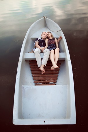 embracing couple in boatの写真素材