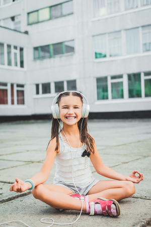 nice girl sitting and listening music with headphonesの写真素材