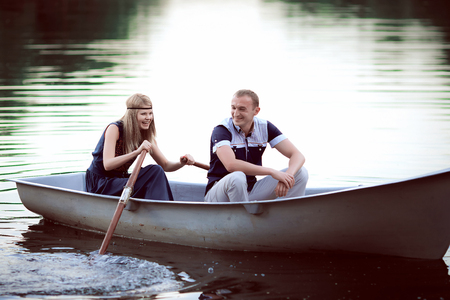 teenager floating on the boatの写真素材