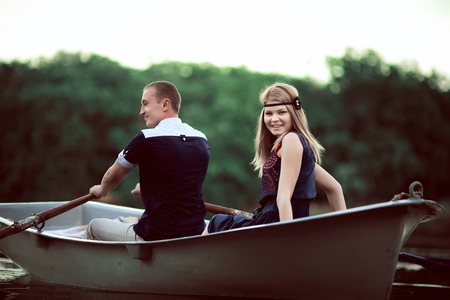 guy and girl floating on the boatの写真素材