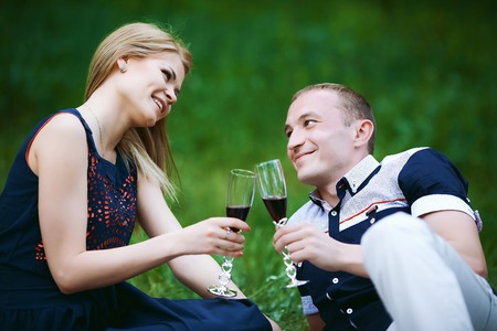 couple holding the glasses with alcoholの写真素材