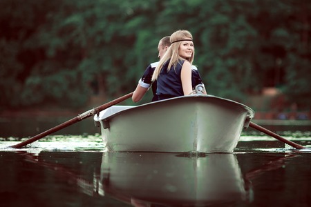girl and boy boating on river
