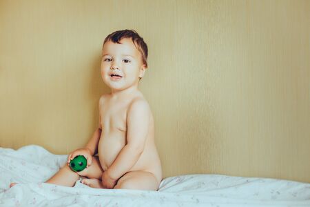 Adorable baby in bedroom with ball