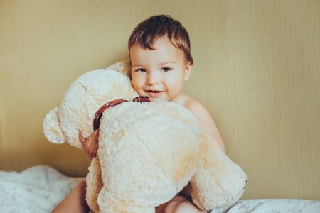 Adorable baby with bearの写真素材