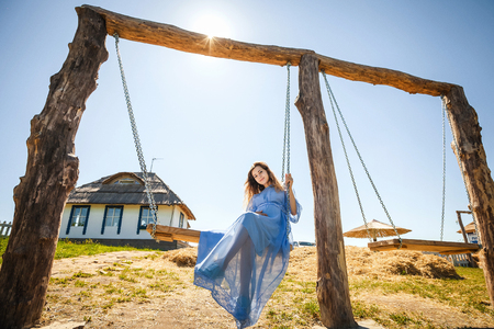 happy girl sitting on swingの写真素材