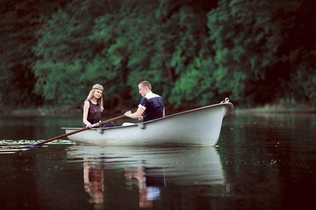 tender couple boating on riverの写真素材