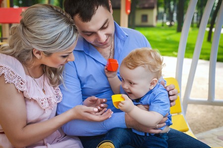 young family walking in park