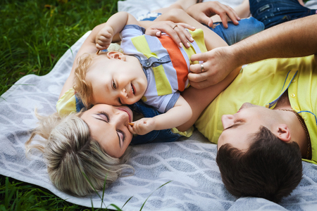 joyful family resting in parkの写真素材