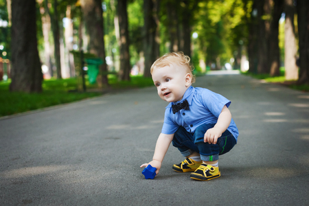 happy boy walking in the park in summerの写真素材