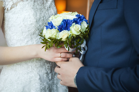 Groom with bride holding wedding bouquetの写真素材