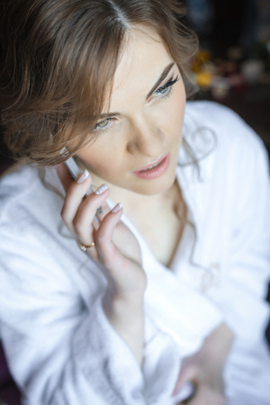 Young bride phoning to her groomの写真素材