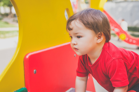 cute child playing on playgroundの写真素材
