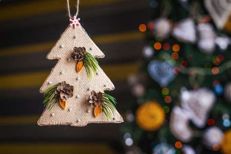 Christmas sackcloth tree. xmas decorations with toys, sparkling, glowing. Happy New Year and Xmas theme . handmade decorの写真素材