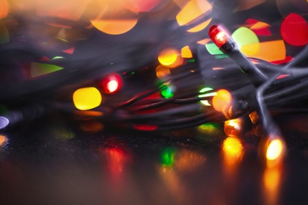 garland with yellow red blurred lights glitter vintage lights background. defocused designの写真素材