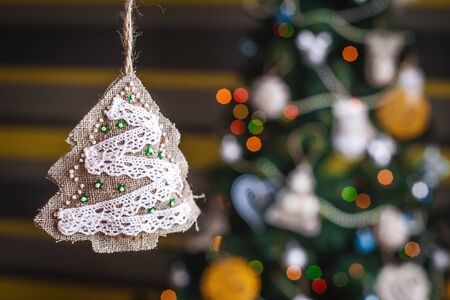 Decorated handmade Christmas tree on blurred, sparkling and fairy background. Happy New Year and Xmas theme. handmade decorの写真素材