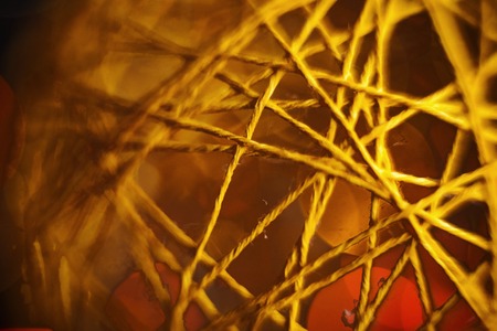 closeup dark yellow beauty blurred twine vintage ball with blurred lights background. defocused designの写真素材
