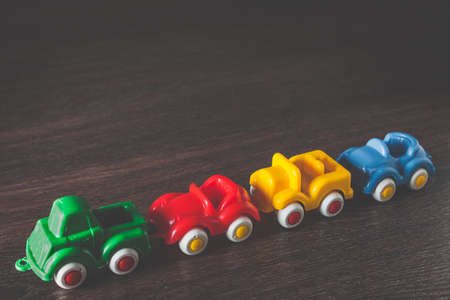 Four color cars model on wooden background with copyspace. concept of car rental, auto car insurance and travellingの写真素材