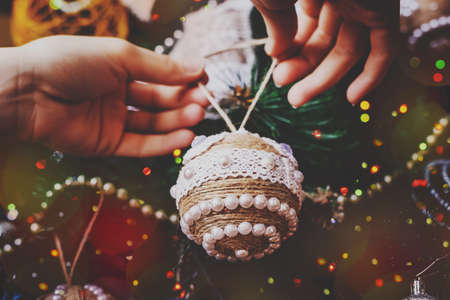 Christmas handmade twine ball on blurred, sparkling and fairy tree background. Happy New Year and...