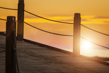 path on the pier at beautiful sunset leading to the beautiful view of red and orange sky. holiday conceptの写真素材