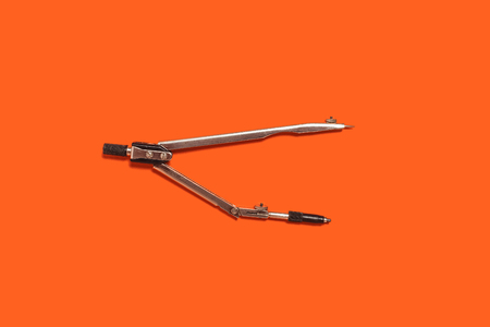 calipers lying on an orange background . concept of office supplies. free space for advertising textの写真素材