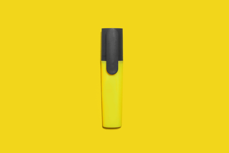 new yellow bright plastic marker lying on a yellow background. concept of office supplies