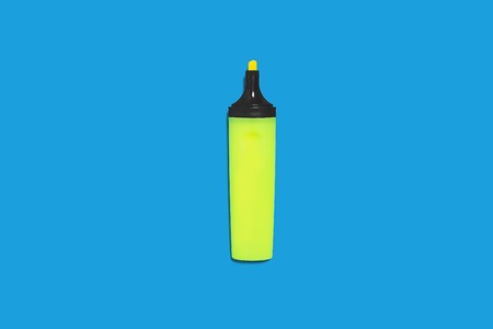 new green bright plastic marker lying on a blue background without a cap. concept of office suppliesの写真素材