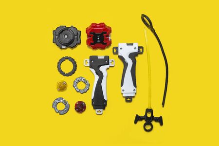 set of kid toys on the yellow surface. Ring, handle, launcher, gyroscopeの写真素材