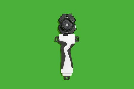 popular blade kid toys. handle with a gyroscope lying on the green backgroundの写真素材