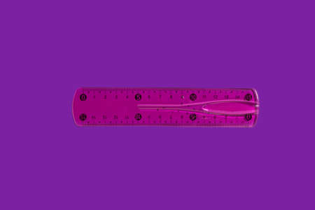 pink ruler on a purple backgroundの写真素材