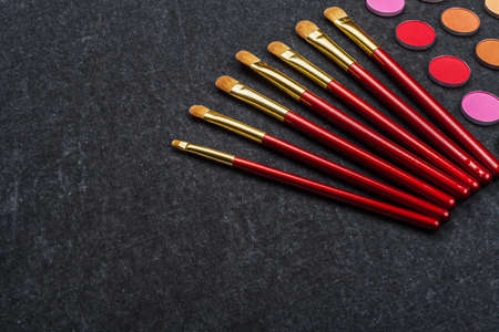 set of brushes near eye shadows on gray layoutの写真素材