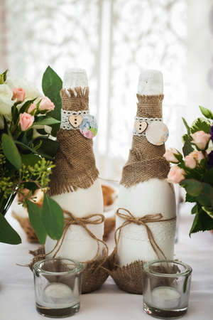 decorated champagne bottles, glasses and flowers. wedding themeの写真素材