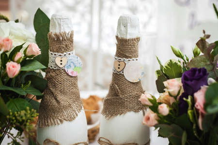 decorated champagne bottles and flowers. wedding themeの写真素材