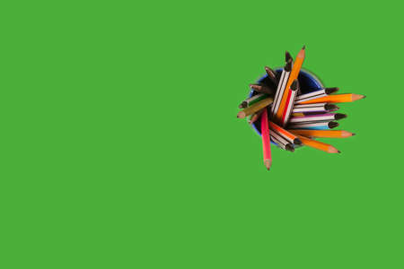 pens and pencils on a green backgroundの写真素材