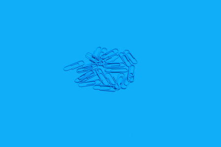 heap of blue paper clips, school accessoriesの写真素材