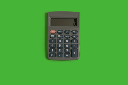 small calculator on a green surface. office accessories