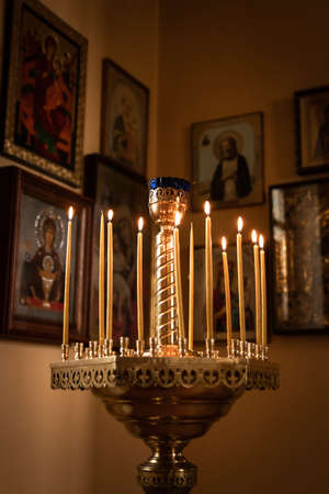 Burning candles in front of icons in the church. Religion, Orthodoxy, temple, iconの写真素材