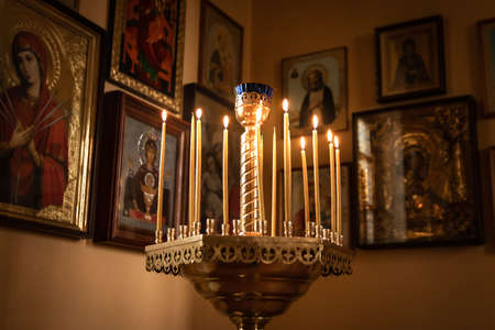 Burning candles in front of icons in the church. Religion, Orthodoxy, temple, iconの写真素材