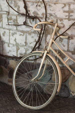 Retro bike is beige indoors. Photo of an old bicycle as an element of the interior. Bike in the cafeの写真素材