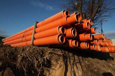 Red plastic water pipes at a construction siteの写真素材