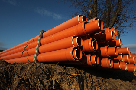 Red plastic water pipes at a construction siteの写真素材