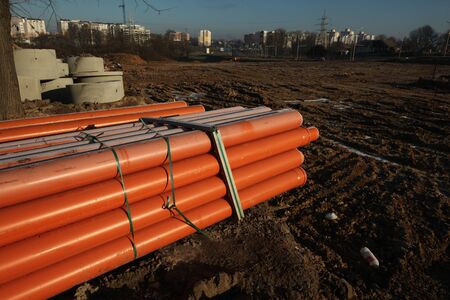 Red plastic water pipes at a construction site