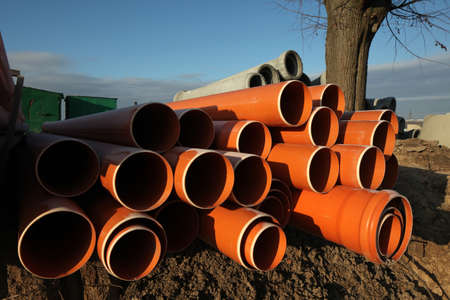 Red plastic water pipes at a construction siteの写真素材