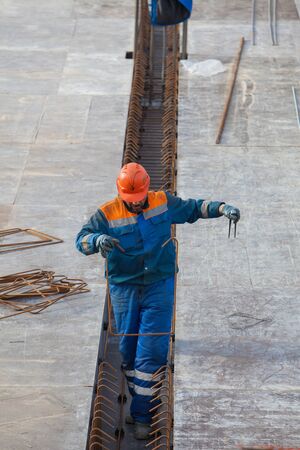 Construction Worker fixes reinforcement on siteの写真素材