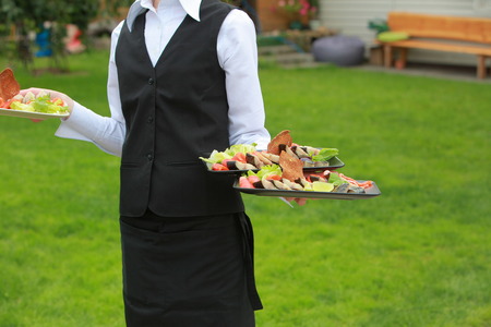 meat, fish, vegetable canapes on a festive wedding table outdoorの写真素材