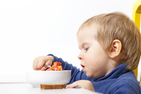 Baby eats vegetable soup spoonの写真素材