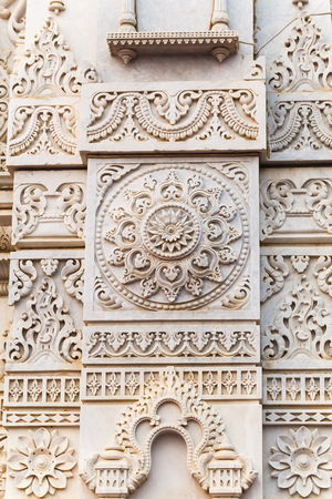Ornament on the white granite wall of the temple in Vrndavanaの写真素材