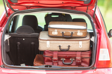Girl happy child travel suitcases car summer landscapeの写真素材