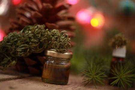 Cannabis oil in a bottle and hemp on a christmas backgroundの写真素材