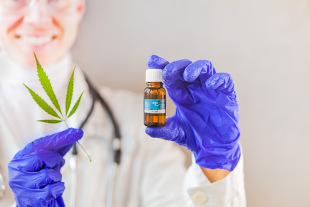 cannabis oil in the doctor's hand hemp leafの写真素材
