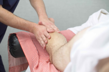 massage therapist makes a man a massageの写真素材